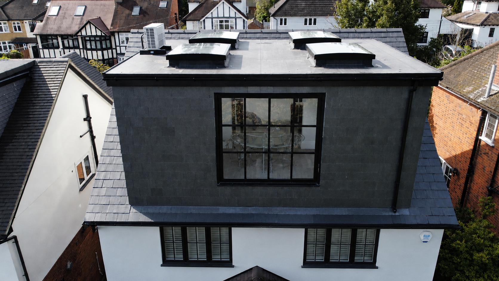 Modern loft conversion interior with skylights and exposed beams